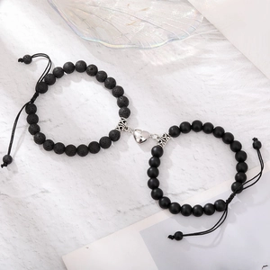 Detail of magnetic heart clasp connecting natural lava stone beaded couples bracelets