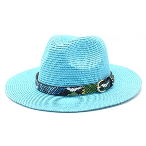 Close-up of bright blue straw sun hat with snakeskin band and gold metal buckle detail