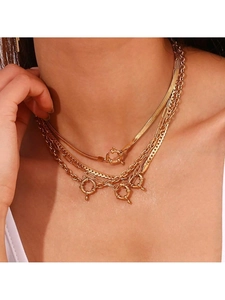 Detail of layered 18k gold plated stainless steel snake and paperclip chain necklaces