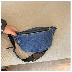 Detail of dark blue denim kids waist bag featuring black zipper and adjustable nylon strap