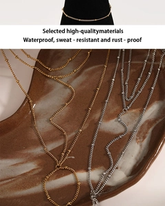 Detail of waterproof stainless steel bead hand back chains in gold and silver finishes