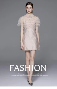 Detail of light pink dress featuring layered lace sleeves and textured jacquard fabric