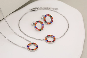 Detail of silver jewelry set with circular pendants and multi-colored rhinestones