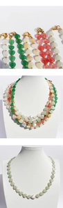 Detail of colorful heart bead necklace featuring gold spacers and heart lobster clasp