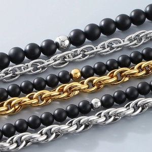 Close-up of black onyx beads and Cuban chain link bracelet with lobster clasp
