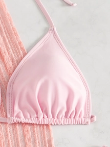 Détail du haut de bikini triangle rose avec cordon de serrage et tissu brillant fini