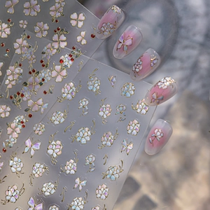 Detail of vintage flower nail art stickers with gold outlines and pearlescent floral designs