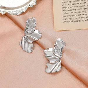 Modern silver irregular flower petal earrings on a pink satin background for women