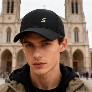 Classic black men's cotton baseball cap with gold S Sports embroidery in outdoor setting