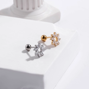 Close-up of stainless steel flower cartilage studs with cubic zirconia and screw back