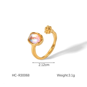 Macro detail of 18K gold-plated open ring with iridescent opal and clustered gold flowers