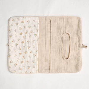 Close-up of baby cotton crib organizer bag featuring floral pattern and muslin fabric texture