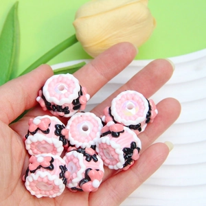 Pink resin cake-shaped handmade beads with black floral patterns for DIY jewelry making