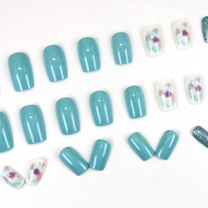 Short light blue press-on nails set featuring floral patterns and silver glitter finishes