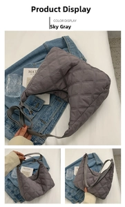 Detail of sky grey quilted crossbody bag with adjustable strap and zipper closure
