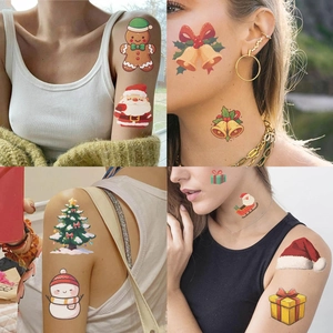 Detail of colorful Christmas temporary tattoos featuring Santa and reindeer on skin