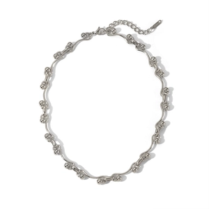 Polished silver stainless steel necklace featuring wavy bars and beads on white background