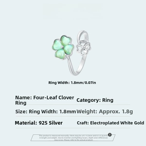 Detail of 925 sterling silver four-leaf clover ring with green cat eye stone inlay
