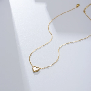 Detail of s925 silver heart necklace with white mother-of-pearl and micro-pave diamonds