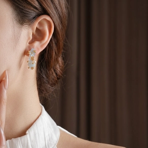 Luxury aquamarine flower C-shape pearl drop earrings shown on model for elegant style