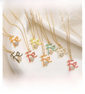 Detail of colorful Fe heart pendants with gold frames and sparkling rhinestones