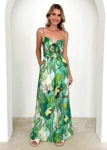 Detail of emerald green abstract print jumpsuit with side cut-outs and bow tie waist