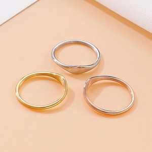 Set of three minimalist titanium steel wave rings in gold, silver, and rose gold finishes