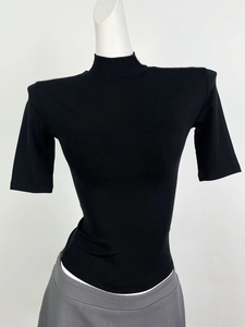 Close-up of black ribbed knit texture on a high-neck slim fit summer top for women