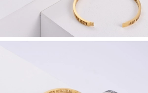 Detailed close-up of Greek key pattern on gold and silver stainless steel bangles