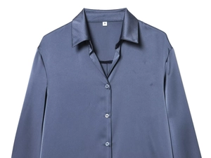 Detailed shot of dark blue satin shirt collar with silver size S label and smooth fabric