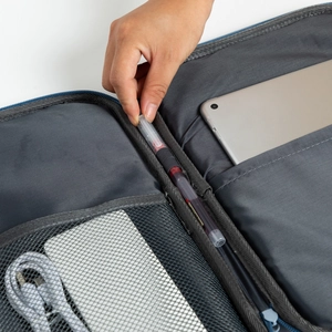 Detailed view of dark grey laptop sleeve interior with mesh pockets and pen slots