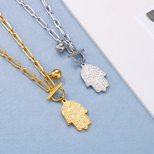 Gold and silver Hamsa Hand necklaces with paperclip chains and OT toggle clasps