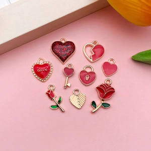 Macro detail of red and gold alloy heart charms including Love engraving and rose designs