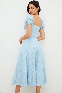 Detail of light blue floral dress showing square neck, puff sleeves and fabric texture