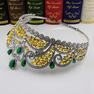 Top view of silver bridal crown with yellow marquise gems and green teardrop crystals