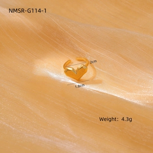 Macro shot of gold heart ring with size measurements and weight on soft peach fabric