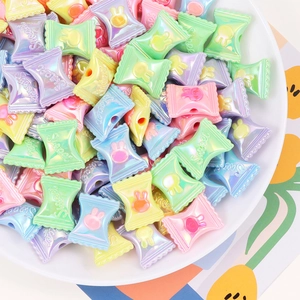 Detailed macro view of colorful acrylic candy and bunny beads for DIY jewelry making