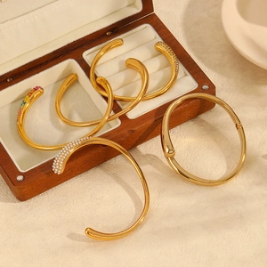 Polished 18k gold-plated stainless steel bangles with colorful zircon in a jewelry box