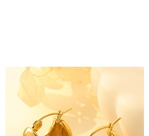 Close-up of golden chunky hoop earrings with textured finish and secure latch fastener