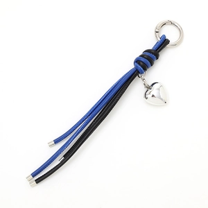 Blue and black leather heart keychain with silver pendant and metal ring on white background