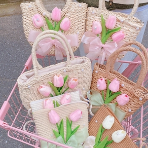 Detail of straw woven handbags with 3D tulips and pearls in a pink shopping cart
