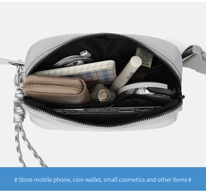 Internal view of a grey waterproof nylon crossbody bag showing storage capacity