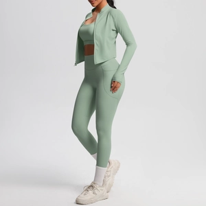 Detail of mint green yoga set featuring high-waist leggings with side pockets and zipper jacket