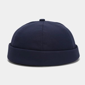 Detail of navy blue cotton docker hat showing the rolled brim and stitching on fabric
