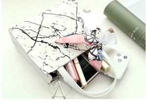 Detailed top view of white marble tote bag with silk scarf showing spacious interior storage