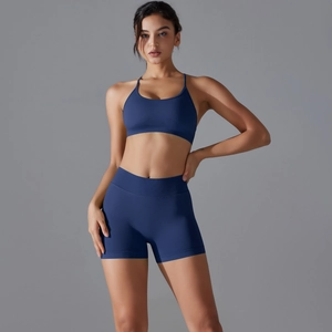 Detail of seamless dark blue yoga set with cross back sports bra and high waist shorts