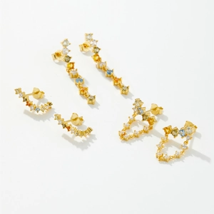 Detailed close-up of S925 silver stud earrings with colorful cubic zirconia and gold plating