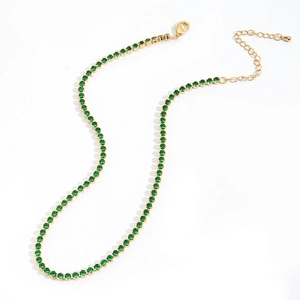 Detail of emerald green zircon stones set in a gold box chain necklace for women