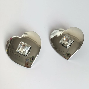 Polished silver heart earrings featuring a centered square crystal on a white background