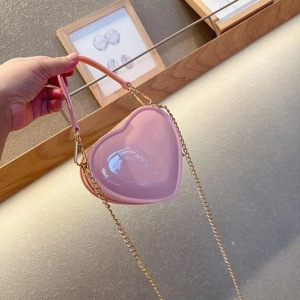 Detailed view of pink heart jelly bag with glossy finish and gold chain strap handle